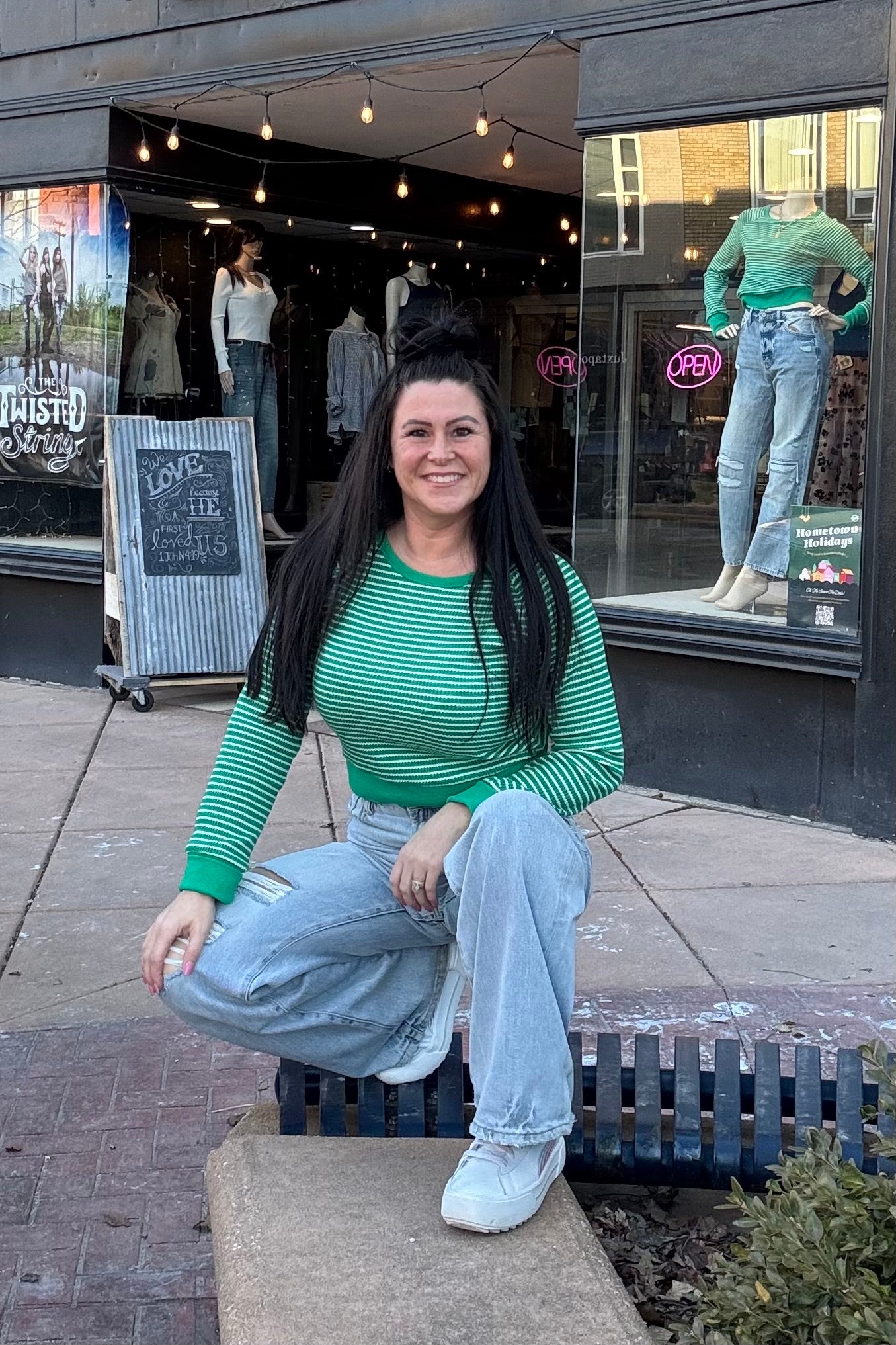 Model wearing green and white cropped long sleeve top