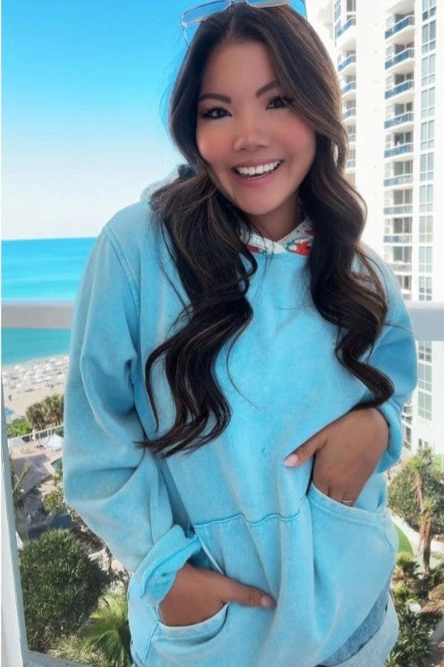 Female model in powder blue hoodie