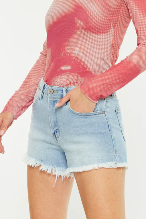Model wearing denim cut-off shorts