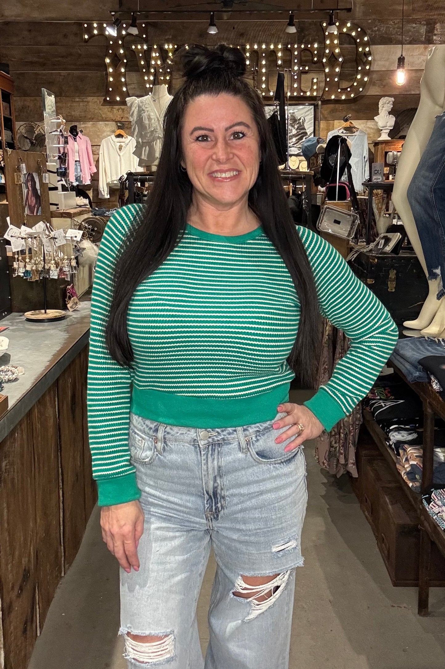 Model wearing green and white cropped long sleeve top