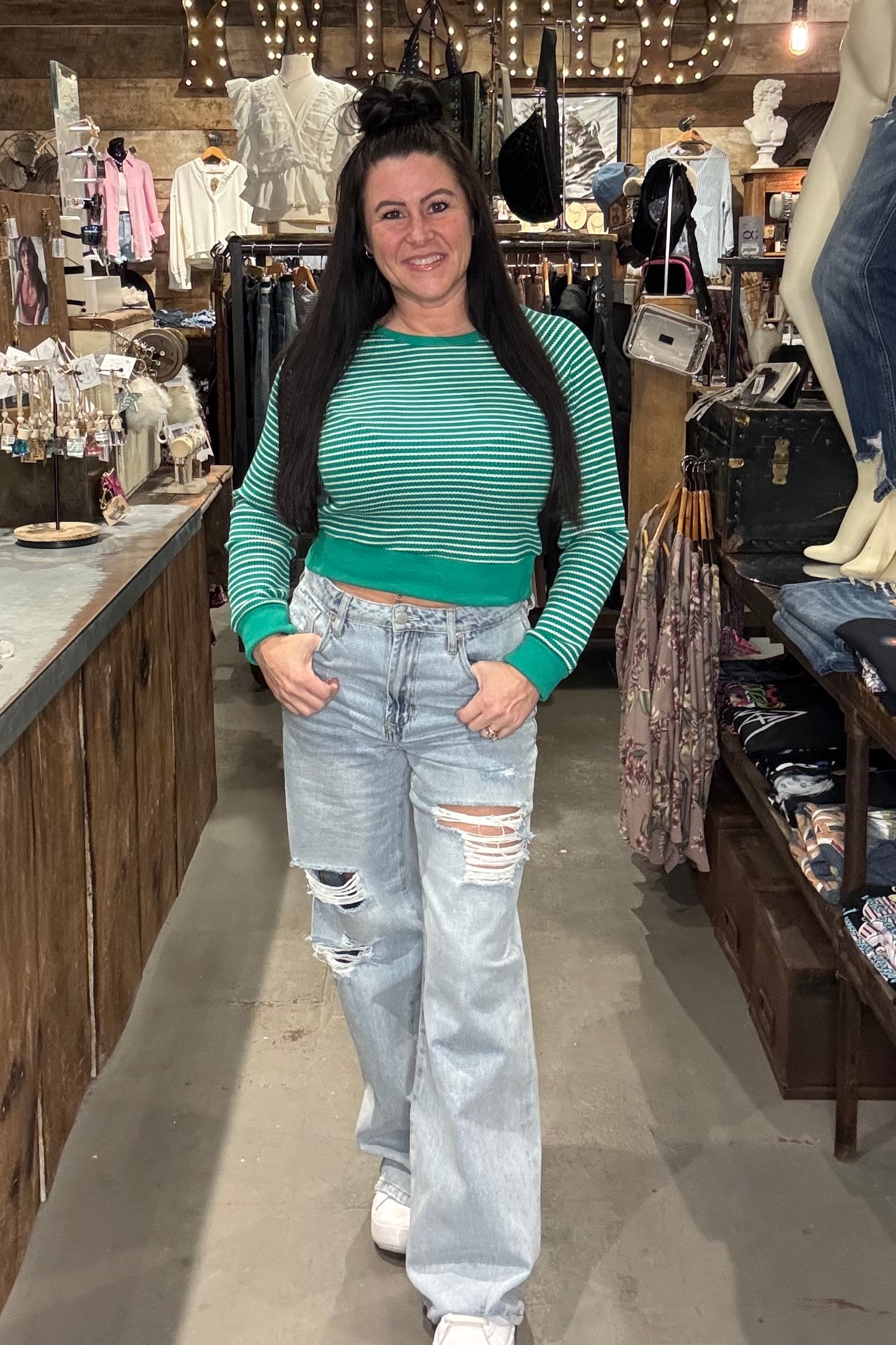 Model wearing green and white cropped long sleeve top