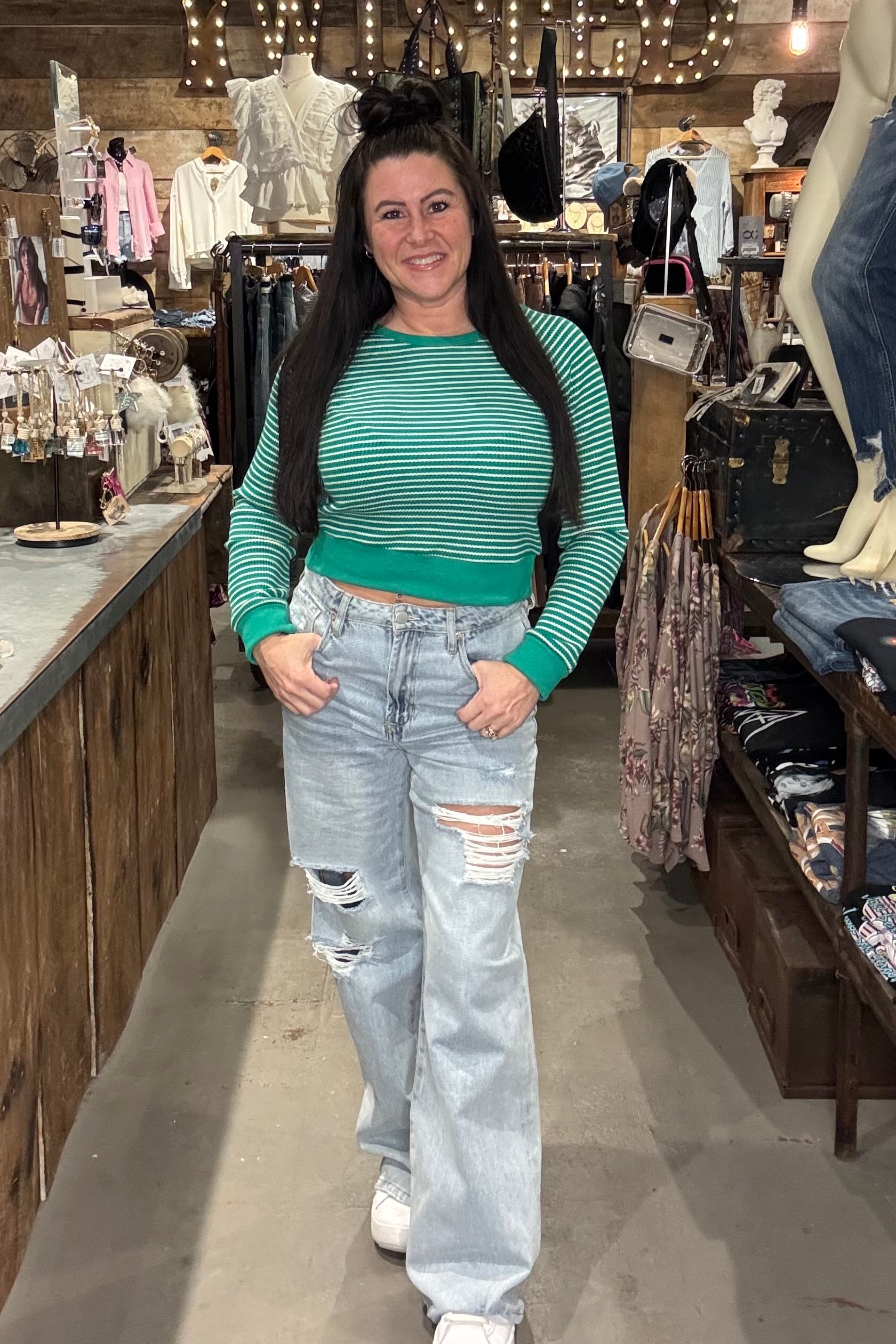 Model wearing green and white cropped long sleeve top