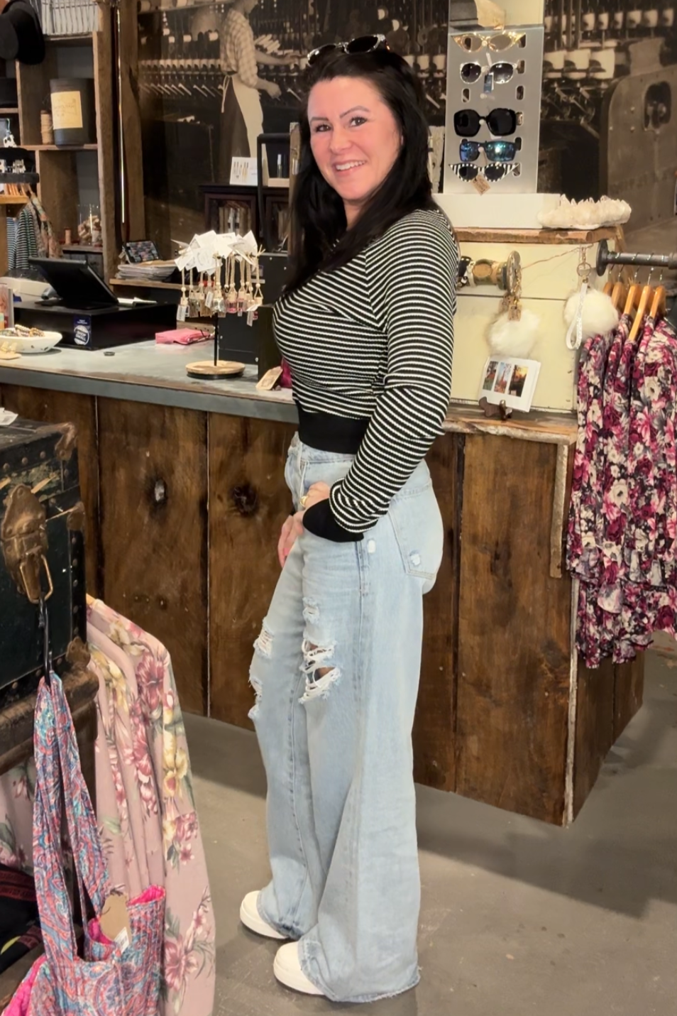 Female model wearing black and white striped crop top