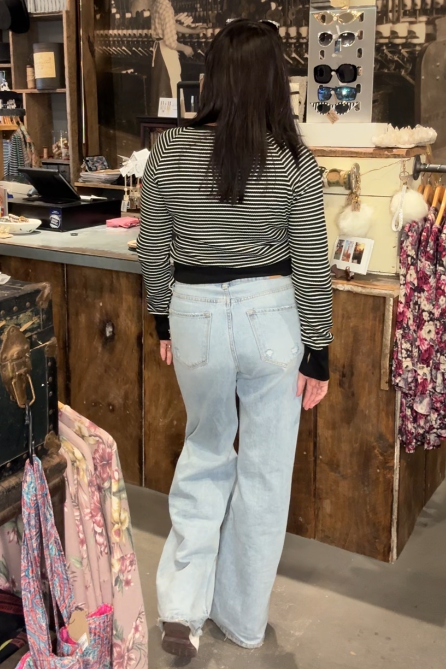 Female model wearing black and white striped crop top