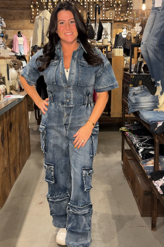 Woman wearing a denim cargo jumpsuit in a store setting