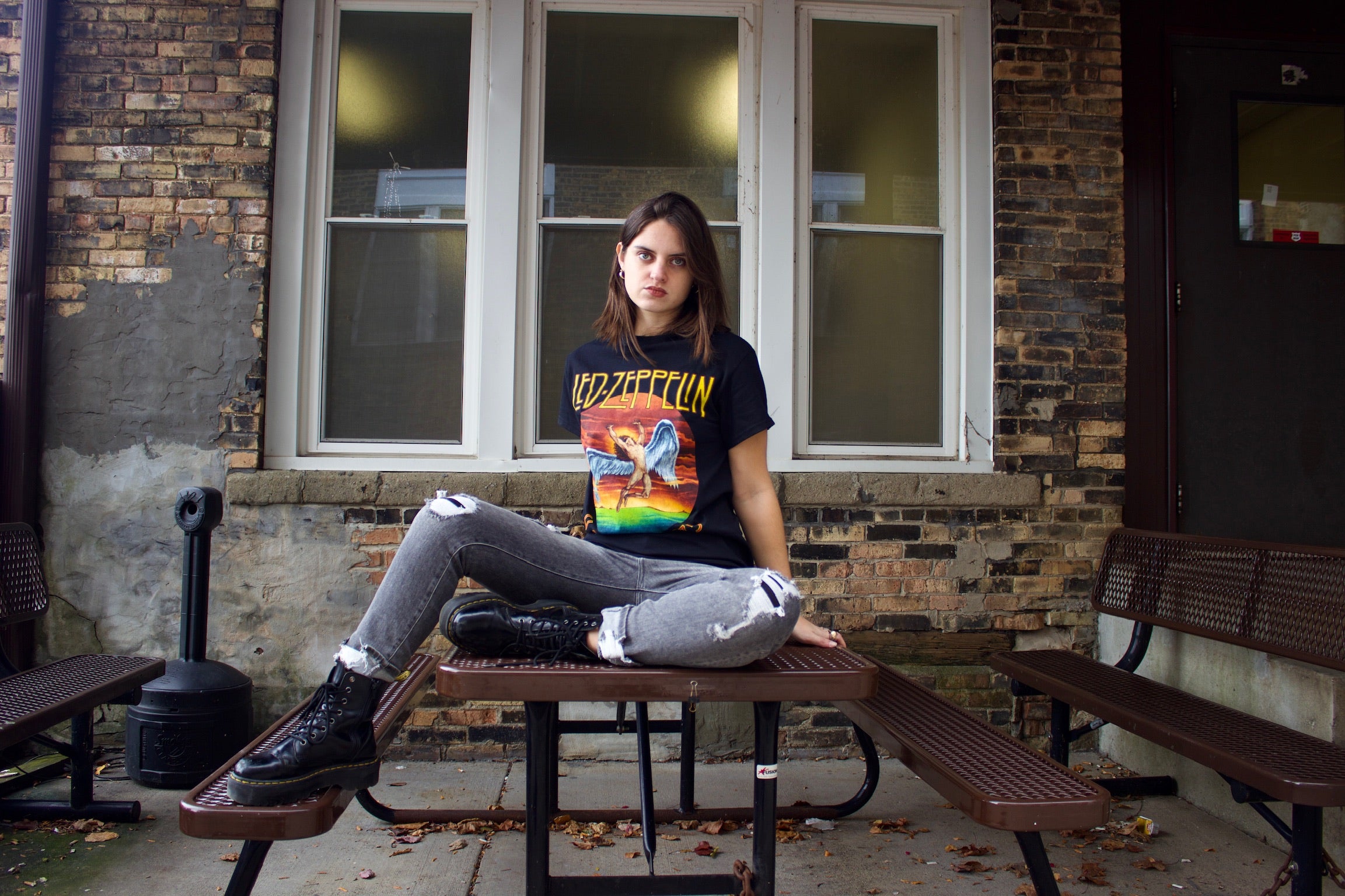 Model wearing an edgy Led Zeppelin band tee and distressed denim jeans
