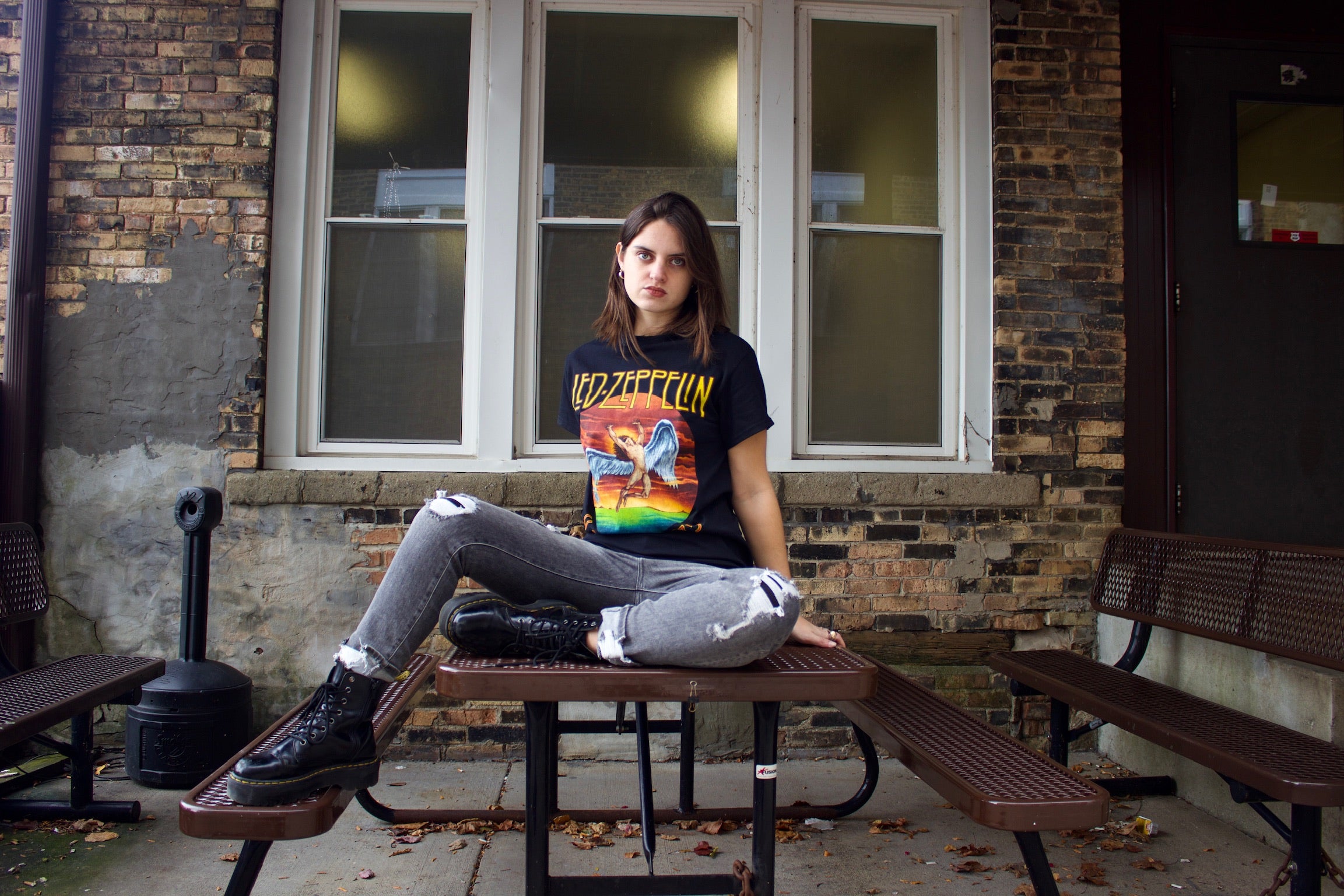 Model on picnic table wearing a Led Zeppelin band tee 