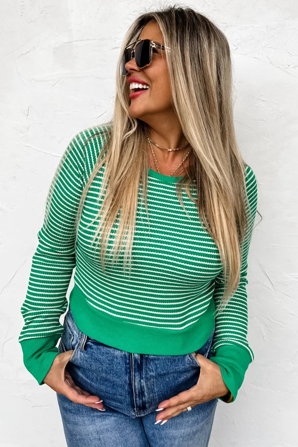 Model wearing a green and white striped crop top