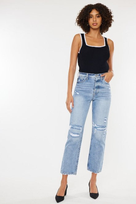 Model wearing a black tank top and light blue wide leg denim jeans