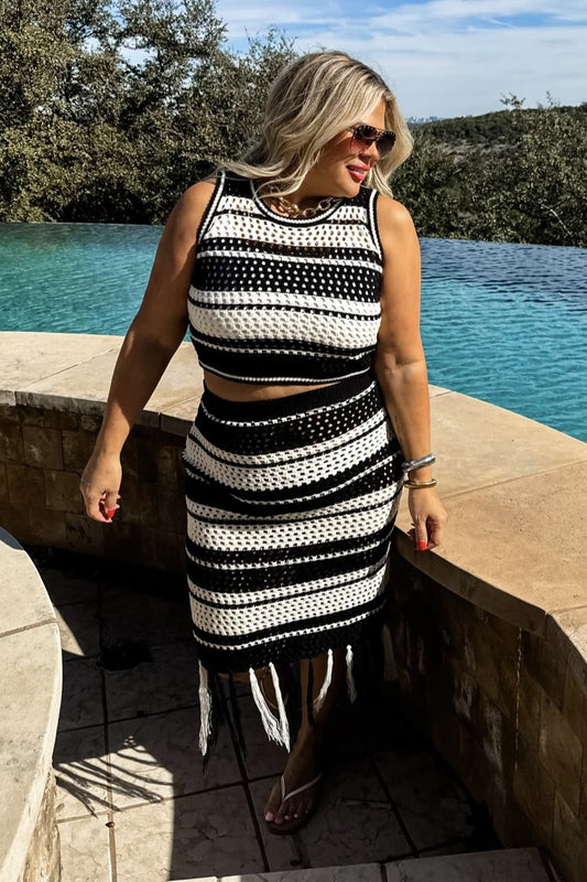 Woman in black and white striped knit skirt set