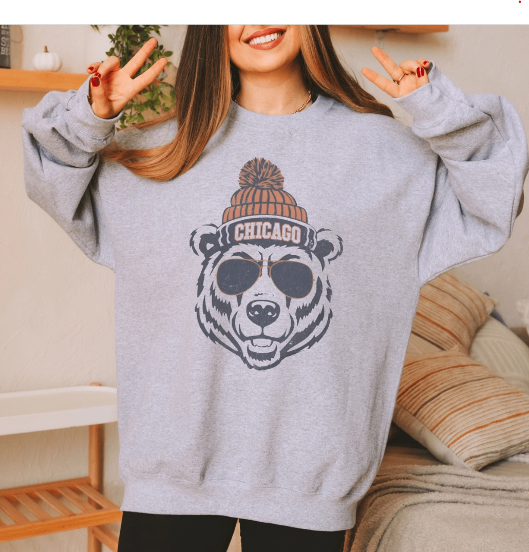 Person wearing a grey sweatshirt with a bear with a beanie graphic and 'Chicago' text team Chicago Bears