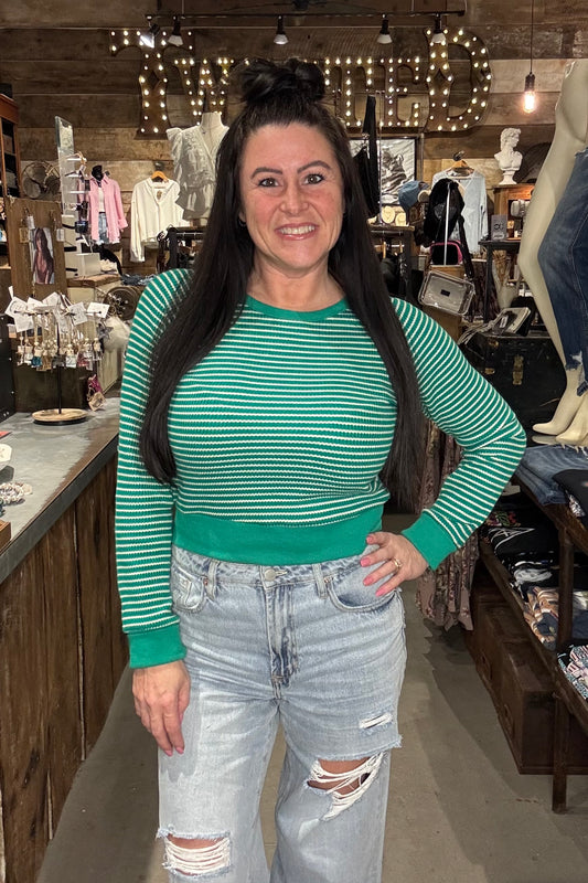 Model wearing green and white cropped long sleeve top