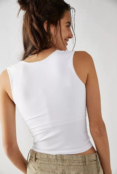 Free People Model wearing a white tank top cami showing the back view